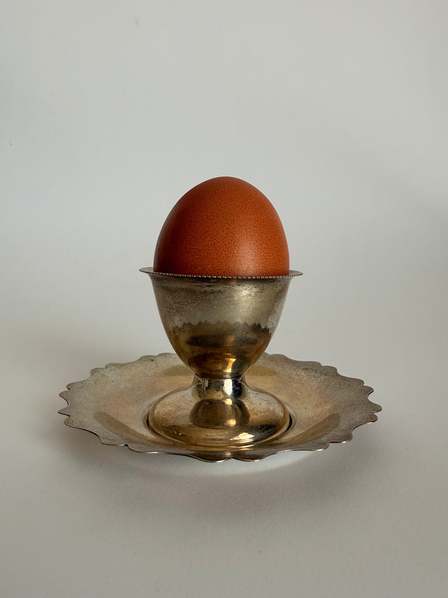 Silver plated egg cup and saucer