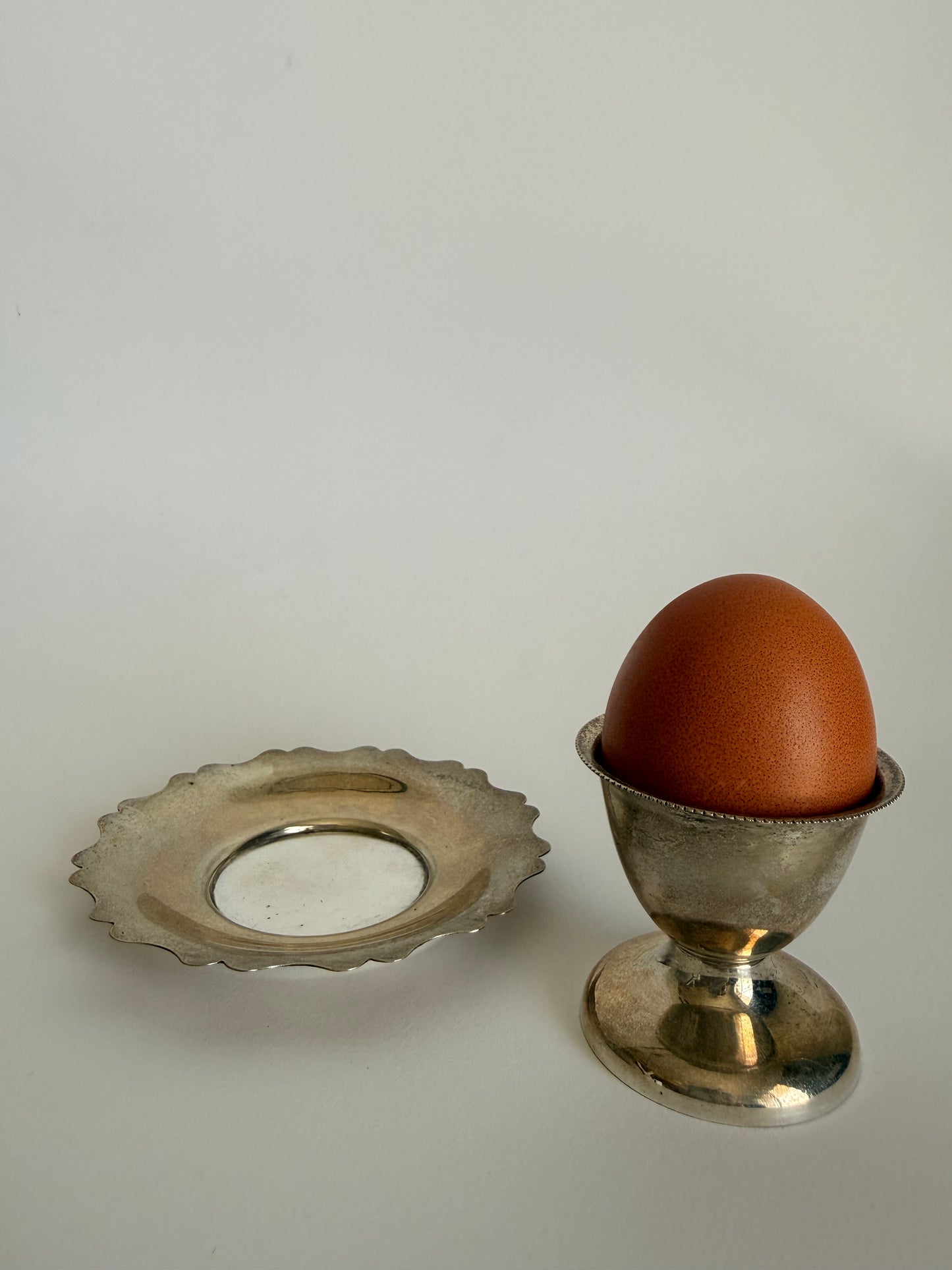 Silver plated egg cup and saucer